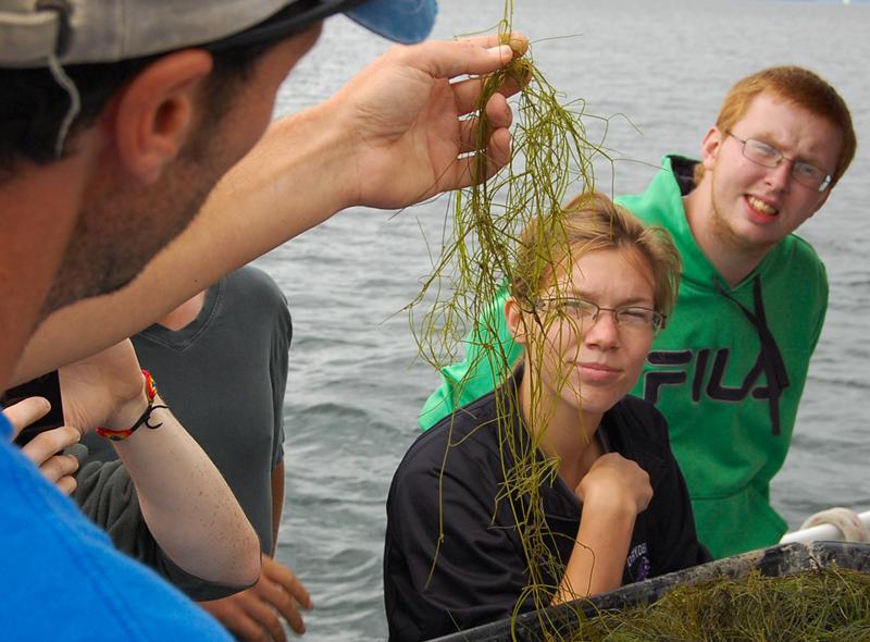 Bill+Foster%2C+Program+Director+of+the+Cayuga+Lake+Floating+Classroom%2C+explains+to+students+how+they+can+collect+plants+and+search+for+the+invasive+species%2C+hydrilla.