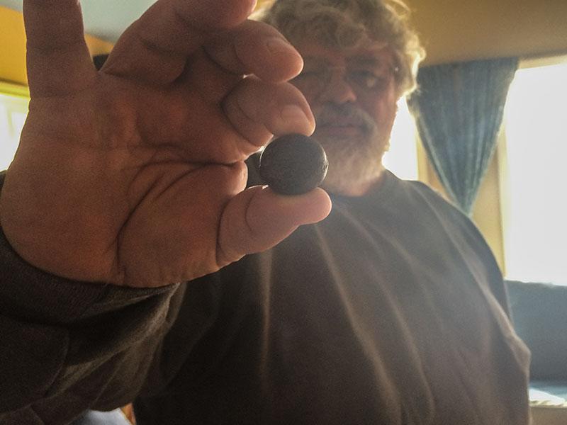 Diver Michael DeGroat holds a Civil War bullet he found at the bottom of Cayuga Lake.