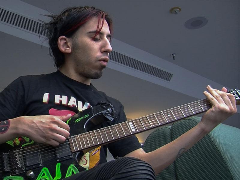 Anton Silv practices Candy Brain's set on his guitar.