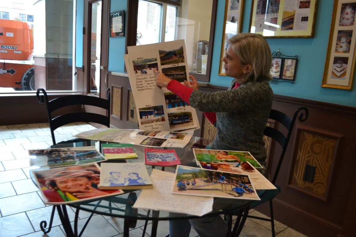 Lisa Lyons shows her mobile office of Educate the Children, Inc. through books and pictures.