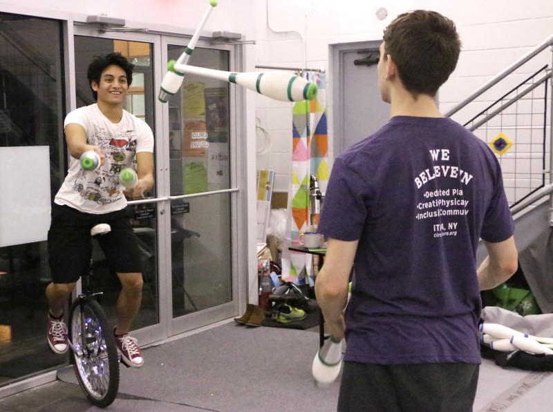 PJ Arroyo balances on his unicycle while juggling with his fellow Juggle Jam attendee Sam Boyles. 