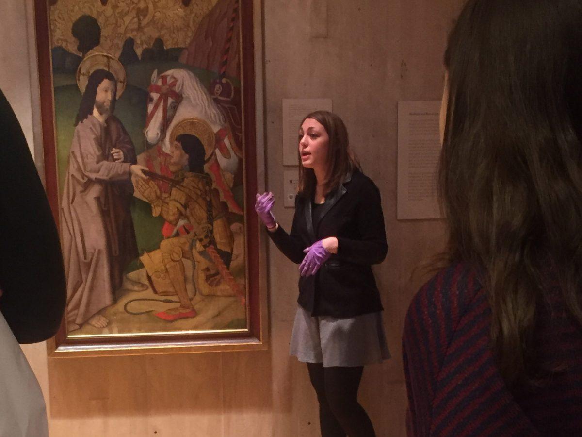 Brittany Rubin talking to one of her classes about the Vergos Workshop’s Christ Appearing to St. Ausias (Ca.1490)