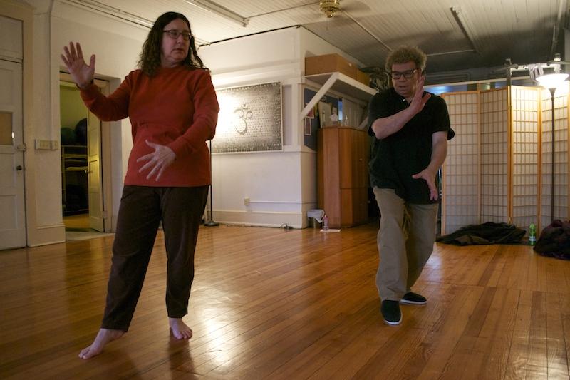 Anthony Fazio performs Tai Ji Quan with a class participant 