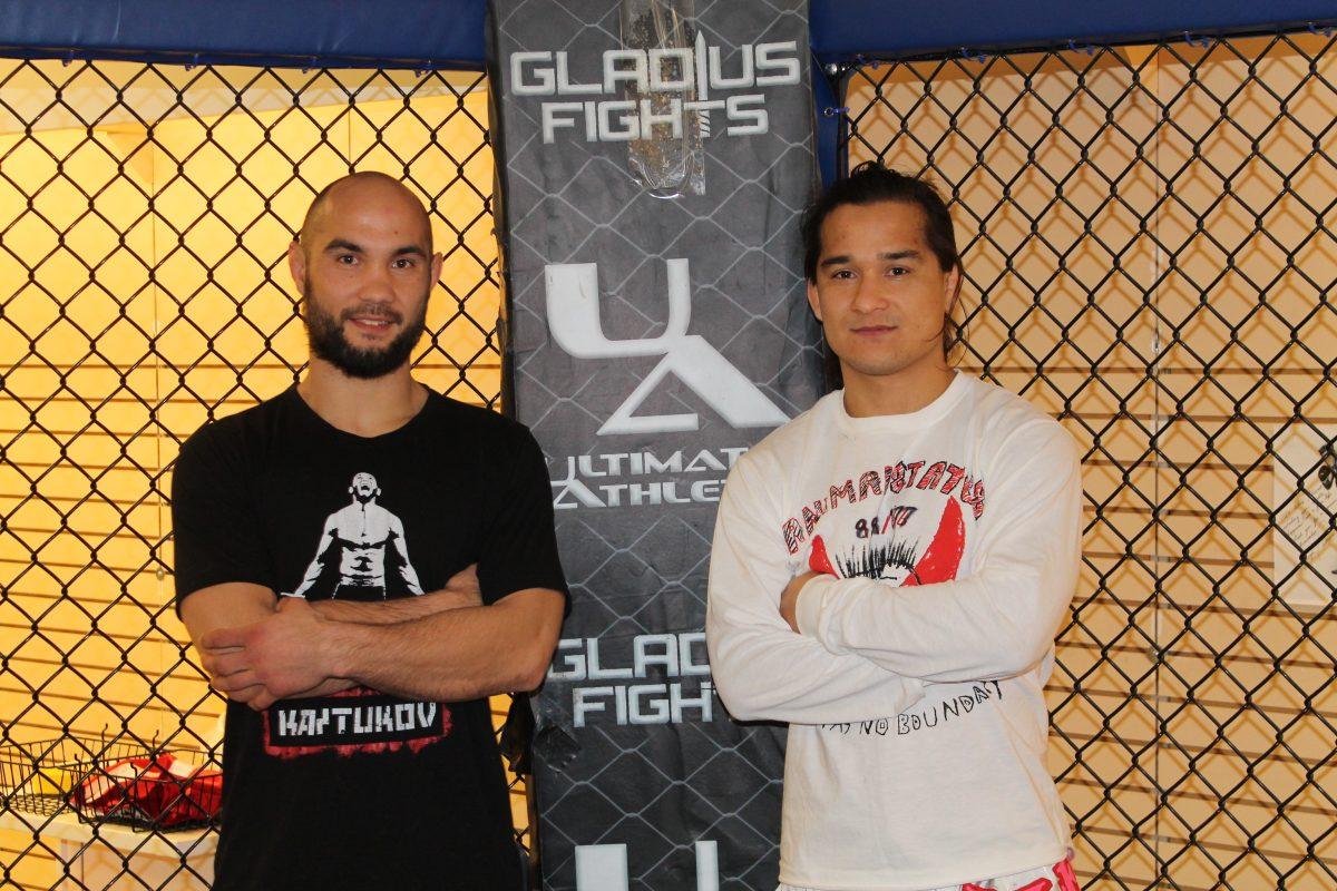Joshua Lange and his brother Kevin pose inside of the new fighting cage at Ultimate Athletics Gym located at Triphammer Mall.