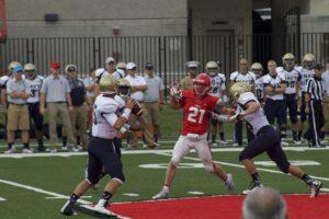 Navy senior quarterback Nick Deterding looks for passing lanes as Cornell senior linebacker John Zelek looks to block or intercept.