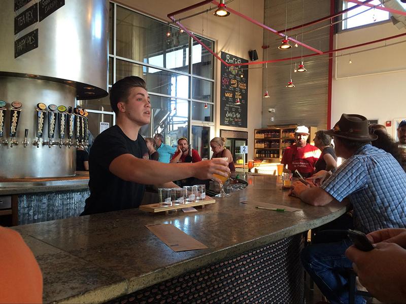 Bartender Jack Storer serves a house brew at the Ithaca Beer Company taproom. © Ithaca Week 2015, Emily Masters and Steven Pirani