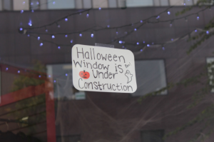 A small sign is taped to the window of a local shop in the Downtown Commons, preceding their decoration for the upcoming weeks. 