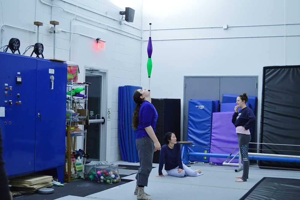 Circus Culture student balances bowling pins on her chin during class.