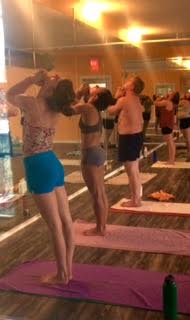 Practitioners at Pure Sweat begin their 90-minute Saturday afternoon hot yoga session.
