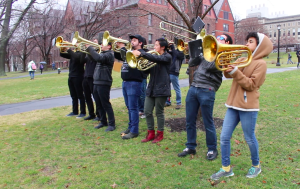 Cornell’s Campus Band plays as the dragon is carried across the grass.