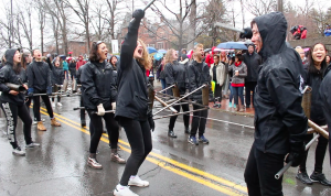 Cornell Architecture students cheer as they carry their dragon across campus.