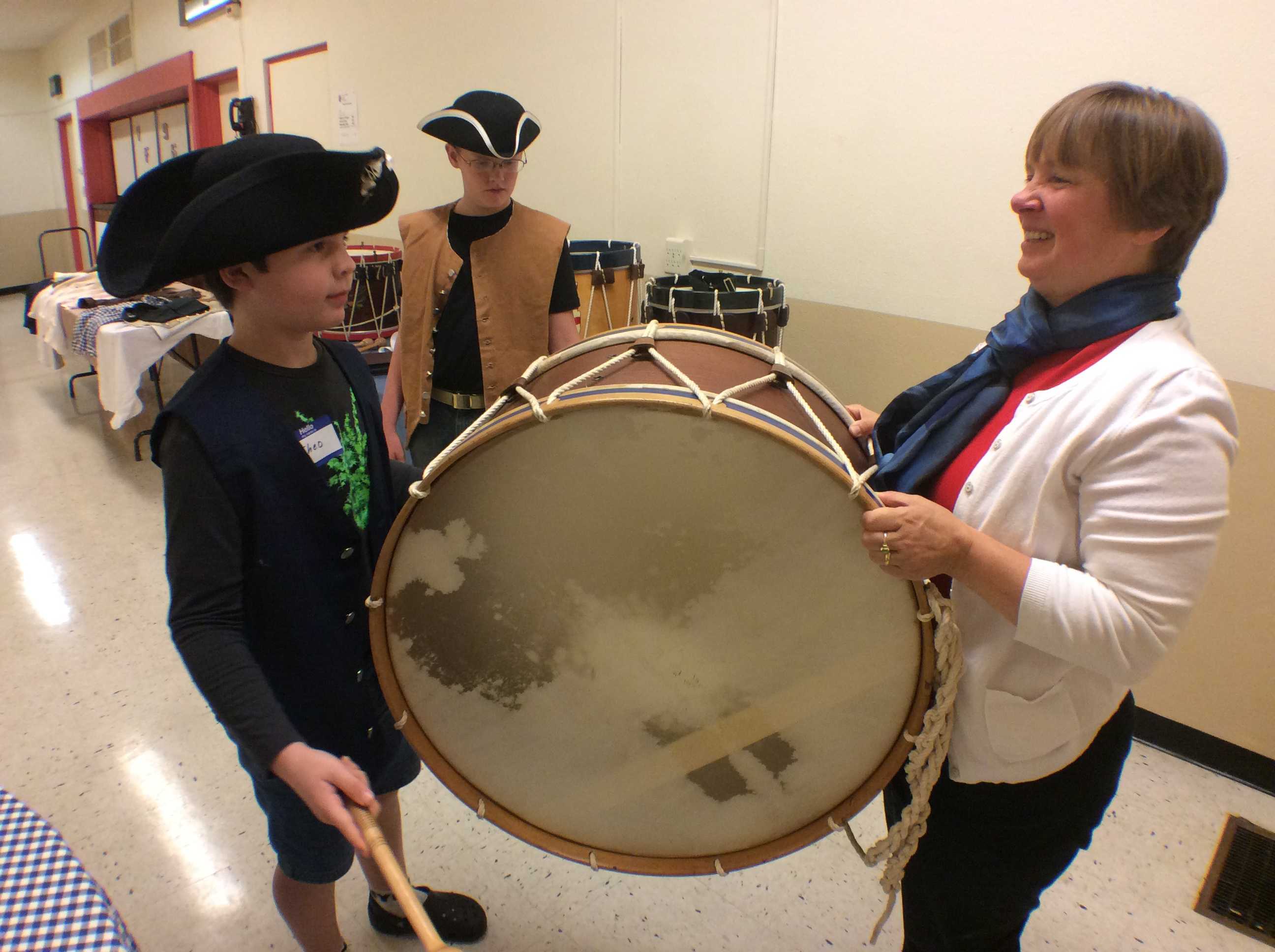 Tanya Morrisett shows off the rope-tension base drum at an open house event. (Photo/Danielle Lee)