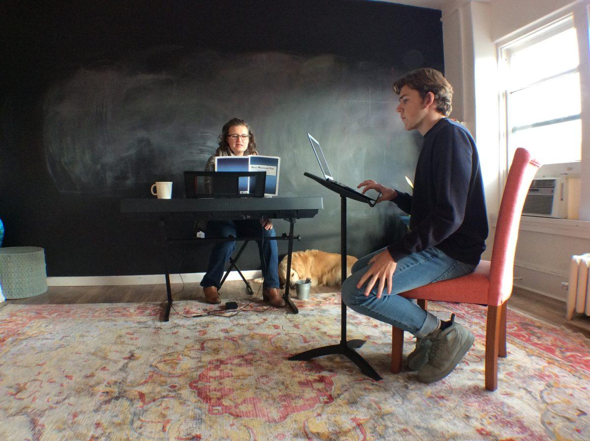 Student Ari Cummings sits with director, Sharon Costianes, during his voice lesson.