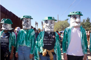 Protesters dressed up as border patrol agents for the Puppetista Parade. Photo courtesy of Diana Castillo.