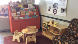 A play area and ‘Free Library’ in the Tompkins Community Action lobby. (Photo by Emily Cartwright/Ithaca Week)