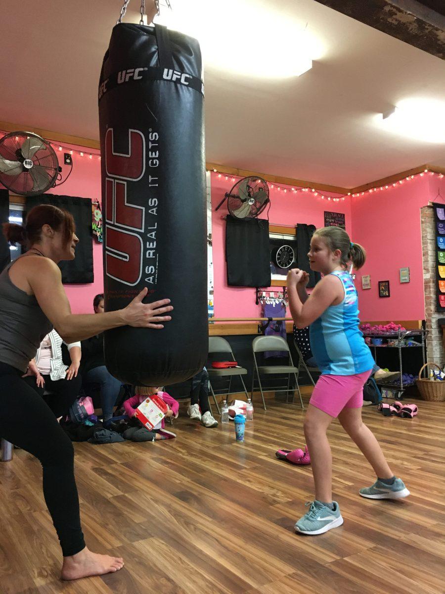 Sophia Polise practices kicks with instructor Jessica Janowsky. (Sierra Guardiola/ Ithaca Week)
