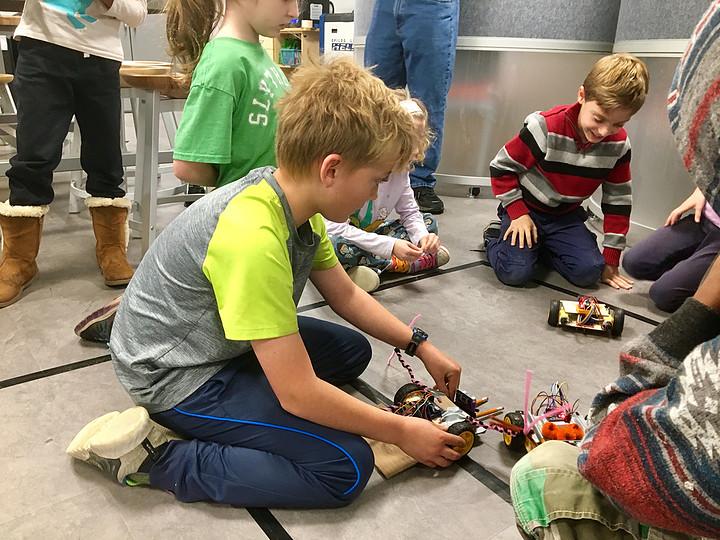Alistair became interested in coding because his dad is a programmer. He added crab claws to his robot to mess with other robots sensors. (Becky Mehorter/Ithaca Week)