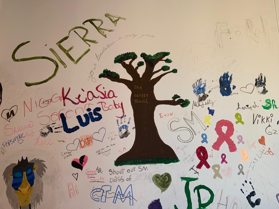 In the middle of the kids art wall is the tree which they call "the center familia," which represents the shelter being the center of their family. (Acacia Krenitsky/Ithaca Week)