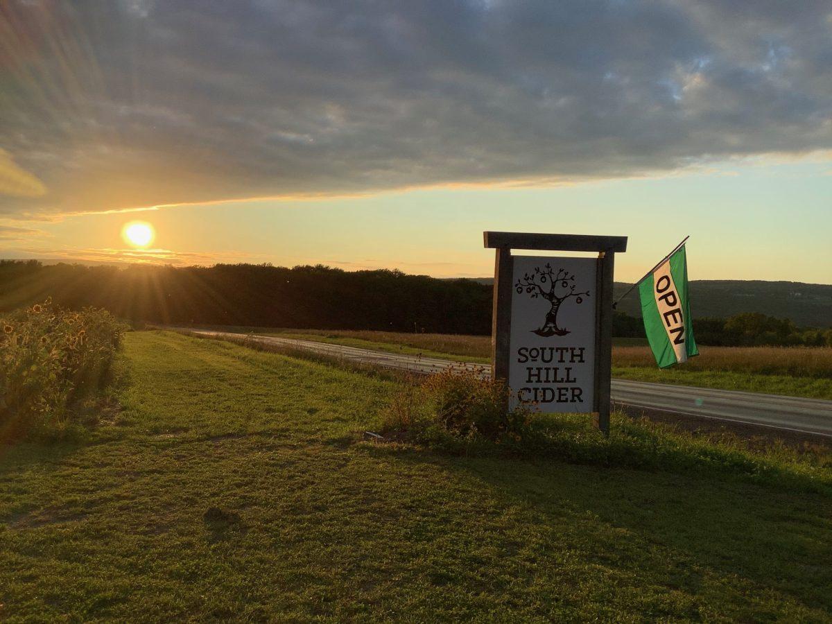 The sun illuminating South Hill Ciders distinct sign and sets right along the orchards skyline view. Captured by: Marlee Pelton-Fuentes
