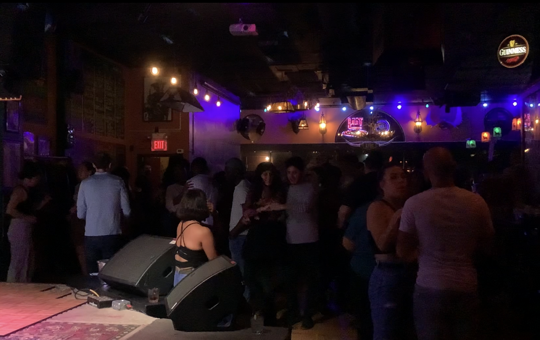 people fill the inside of The Range, a country and western bar. The dance to salsa music in the dimly lit room