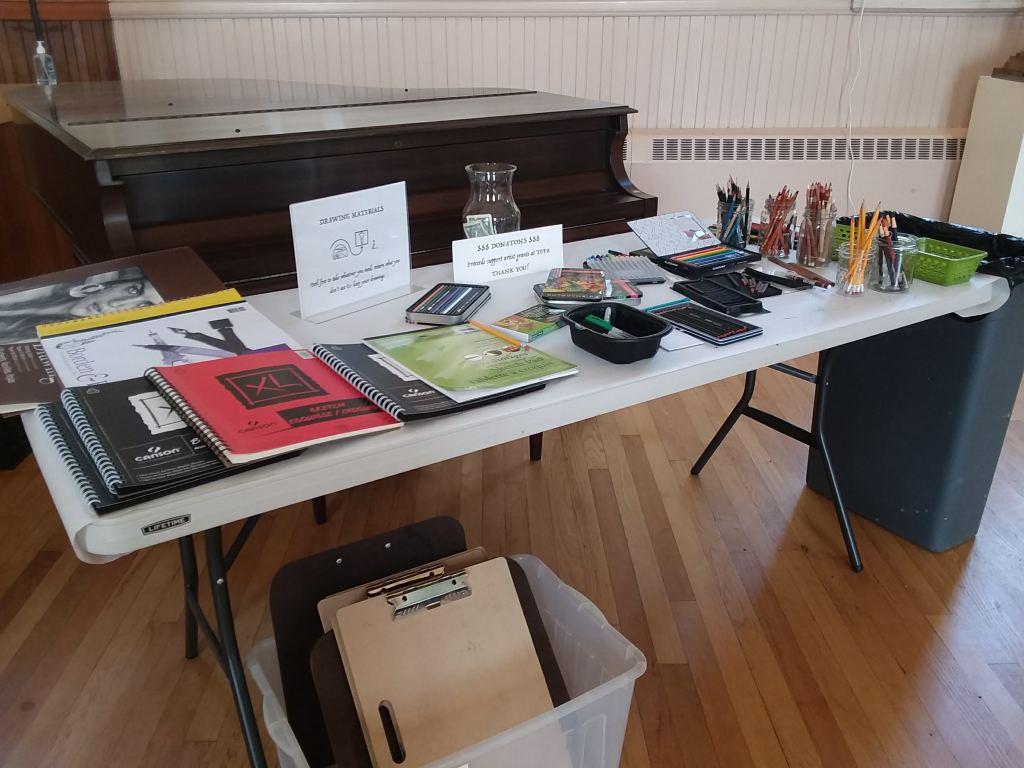 Picture of a table filled with drawing supplies